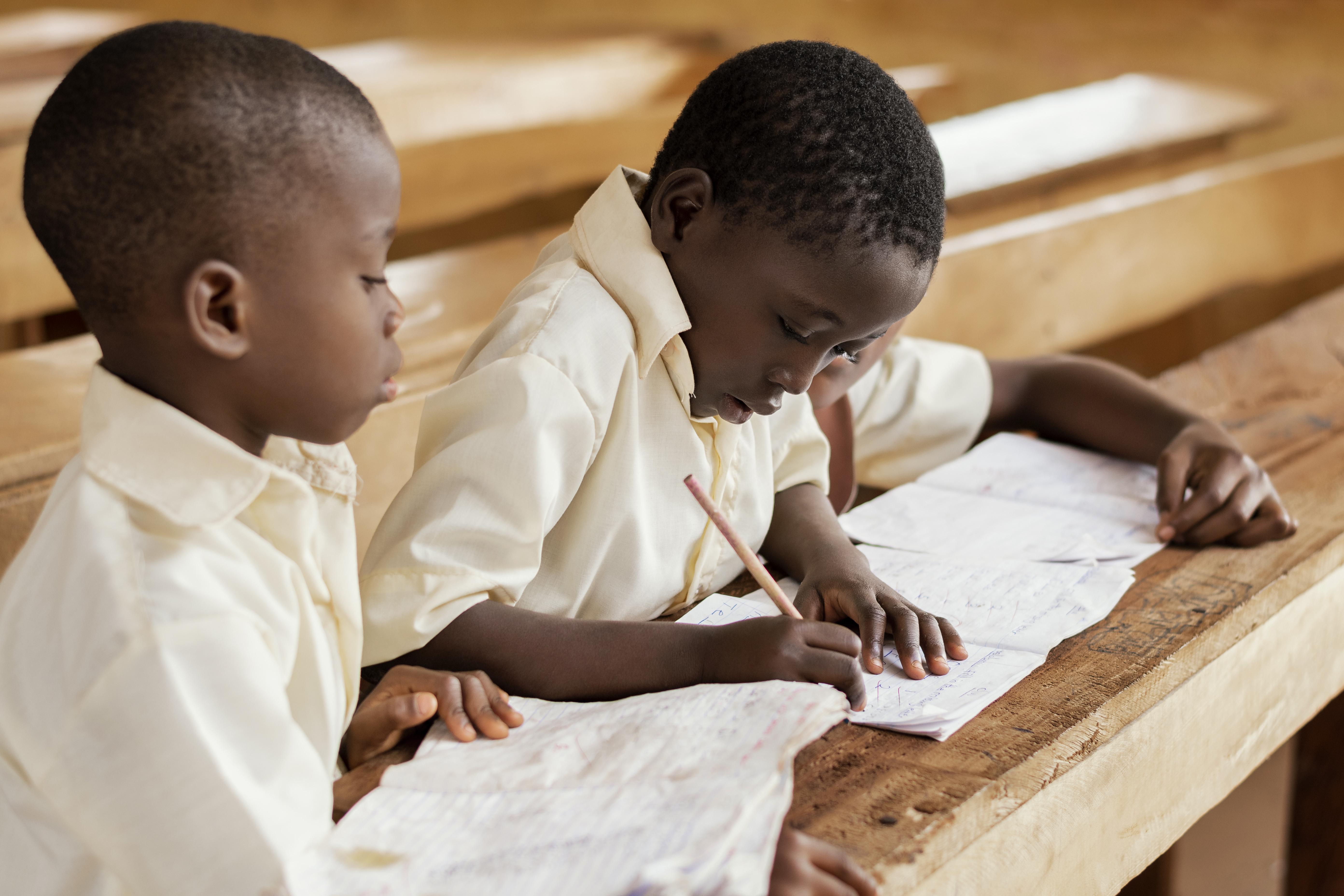 A teacher guiding young children in a Montessori classroom