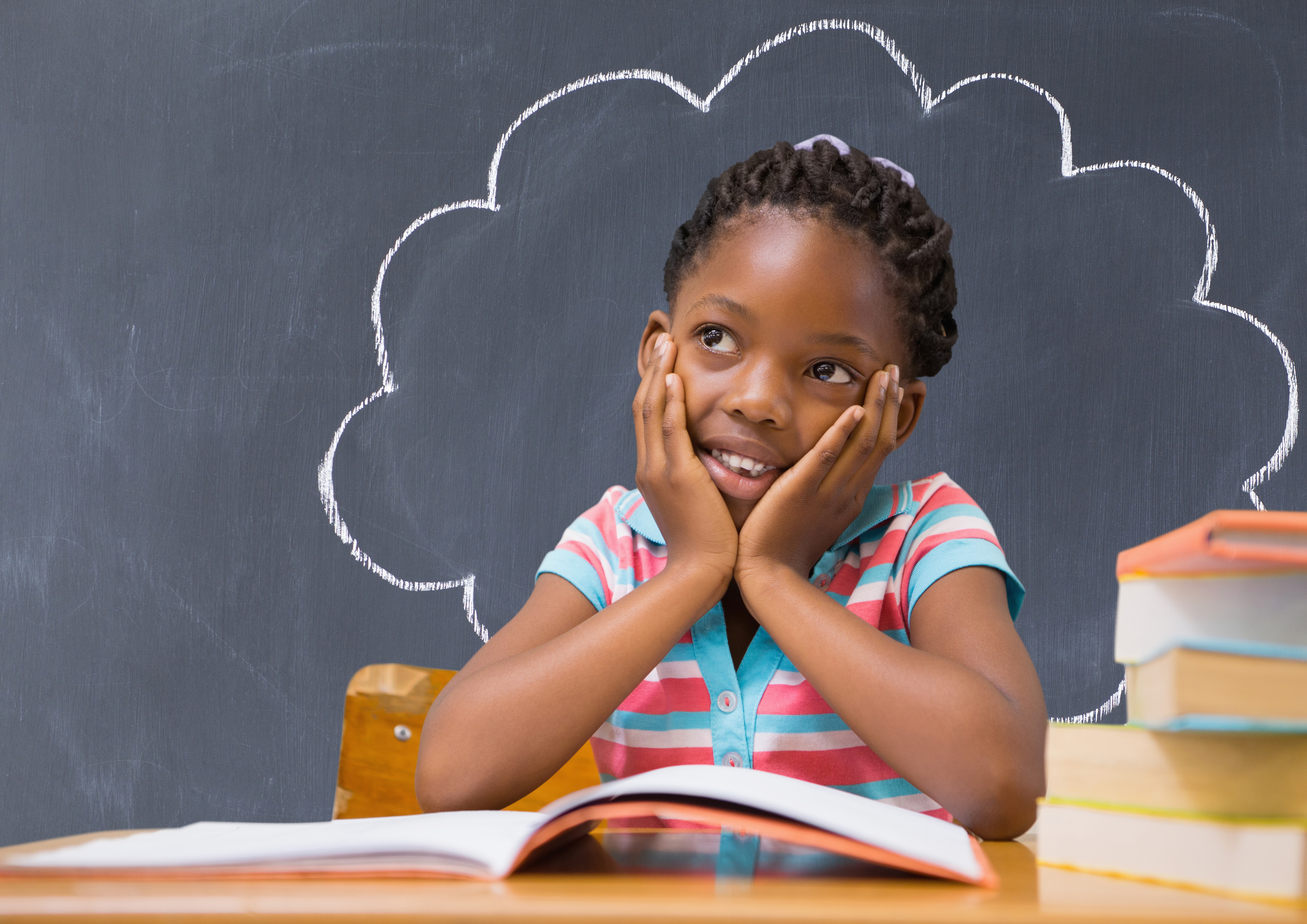 A child concentrating on colourful Montessori sensorial materials