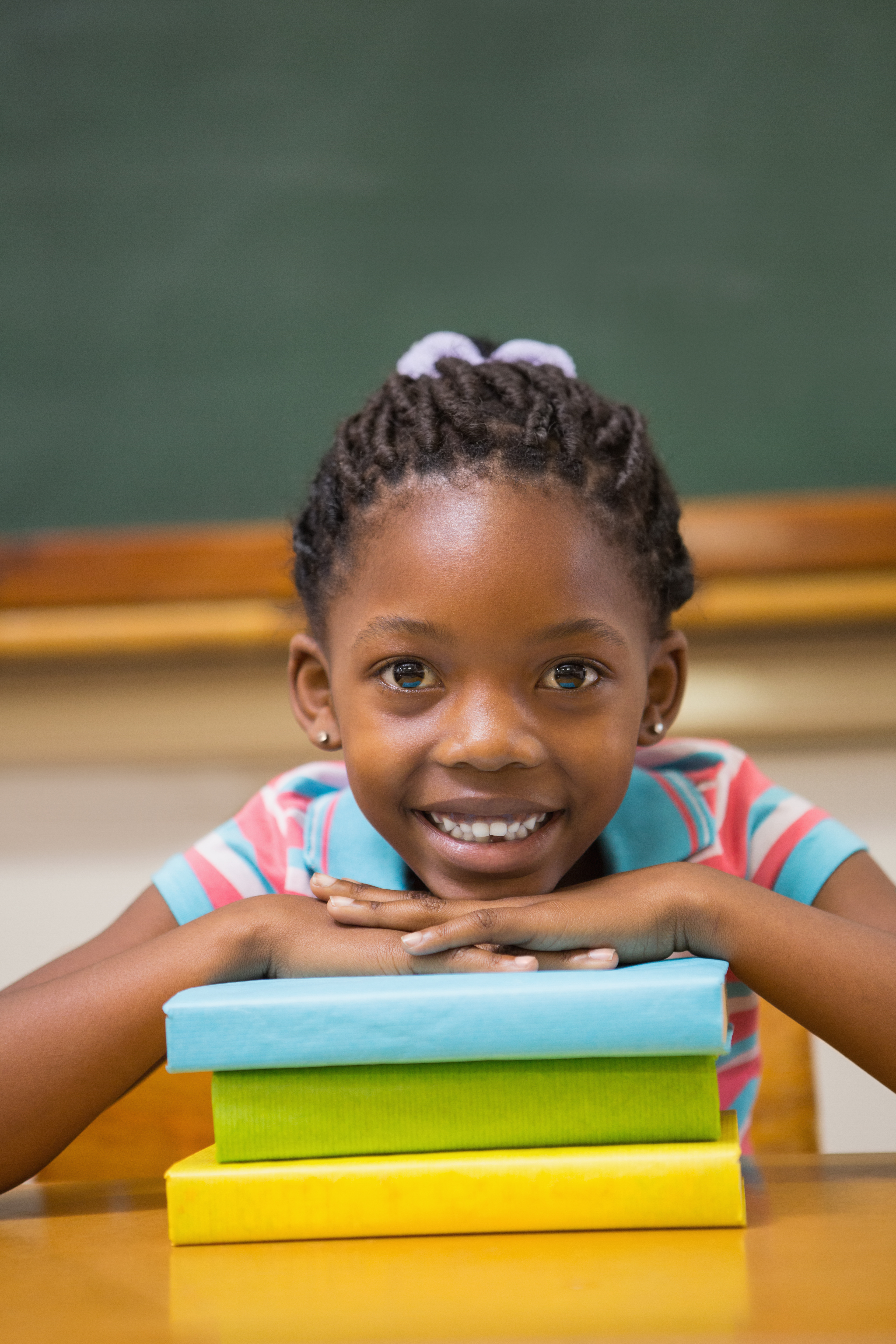 A smiling child at a bright Montessori table with colourful materials